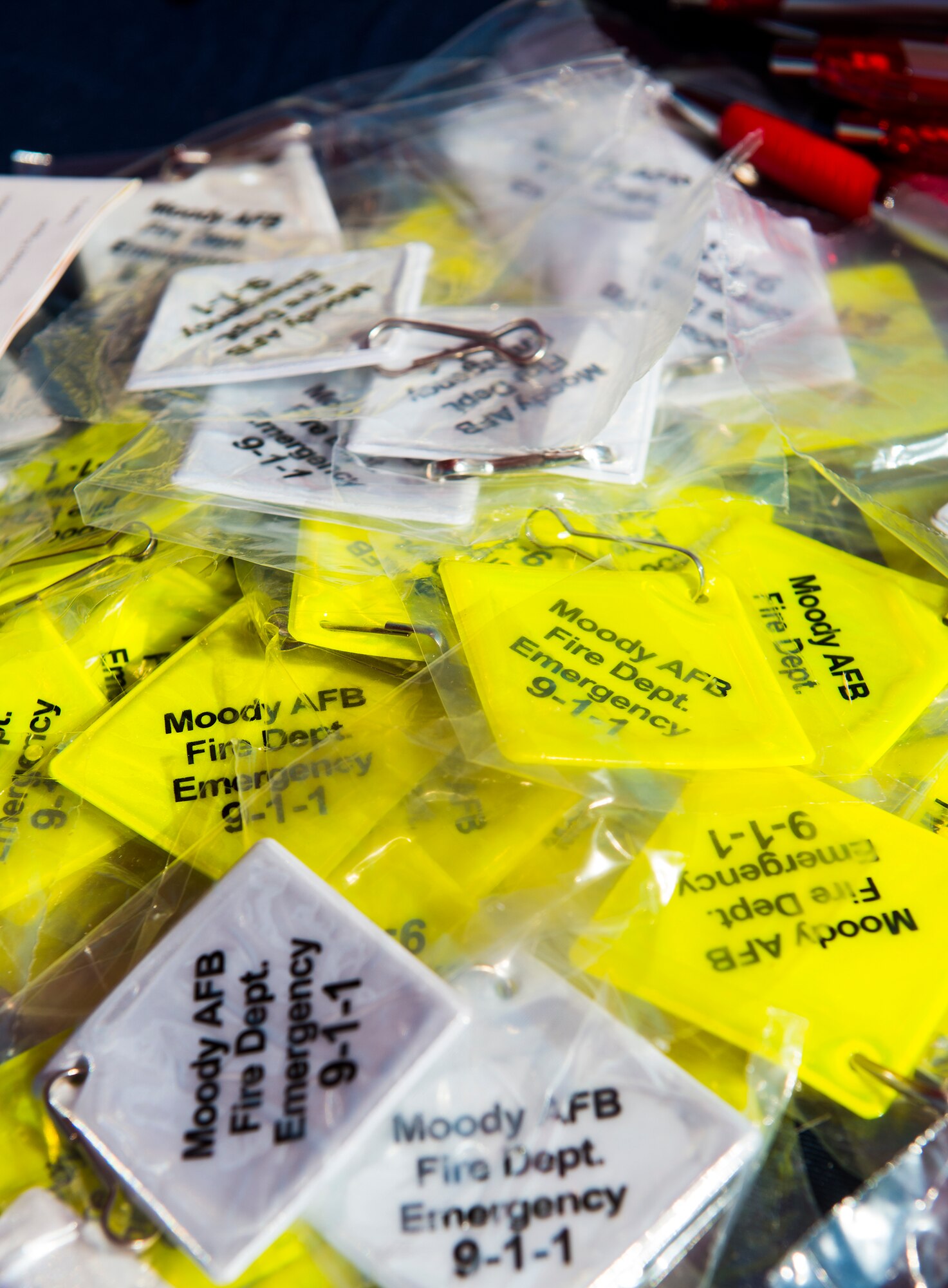 Fire prevention keychains rest on a display table during the National Fire Prevention Week Open House Oct. 11, 2014, at Moody Air Force Base, Ga. Moody’s Fire Prevention Week is designed to raise fire safety awareness at Moody. (U.S. Air Force photo by Airman 1st Class Ceaira Tinsley/Released)