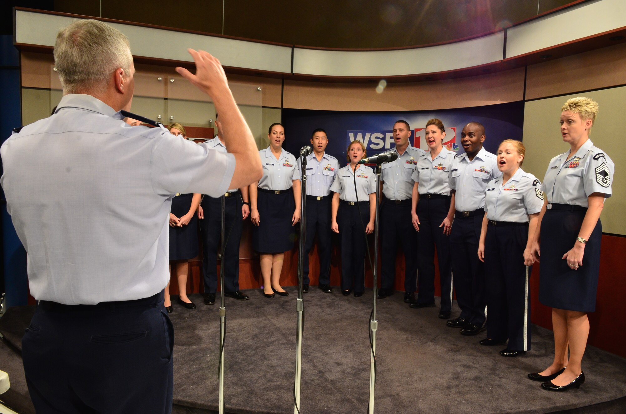 Col. Larry Lang rehearses members of the Singing Sergeants before going on-air at Alabama Live! on WFSA, Channel 12 in Montgomery, Alabama. (U.S. Air Force photo by Senior Master Sgt. Bob Kamholz/released)
