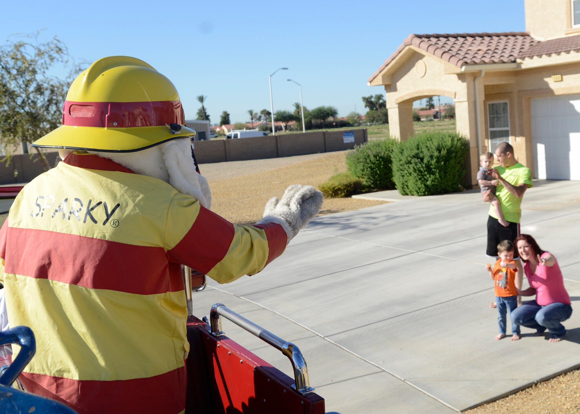Sparky, the Fire Dog, waves to base housing residents Saturday during the fire prevention week parade. The parade consisted of members and vehicles from Luke’s fire department and the Hall of Flame Fire Museum. (U.S. Air Force photo/Senior Airman Devante Williams)
