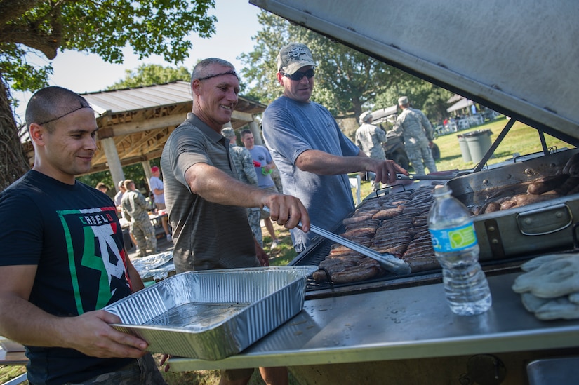 Master Sgt. Kenneth Helton, 628th Civil Engineer Squadron assistant noncommissioned officer in charge of heating, ventilating and air conditioning, Master Sgt. Zach Peters, 628th CES NCOIC of structures, and Tech. Sgt. Perry Morlando, assistant NCOIC of structures, grill bratwurst for hundreds of Joint Base Charleston Airmen and Sailors during Oktoberfest Oct. 10, 2014, at the dorm picnic area on JB Charleston, S.C. The event celebrated the contributions, sacrifice and service of JB Charleston’s first six (E1-E6) personnel, and featured free food, games, drinks and fun.  (U.S. Air Force photo/Airman 1st Class Clayton Cupit)