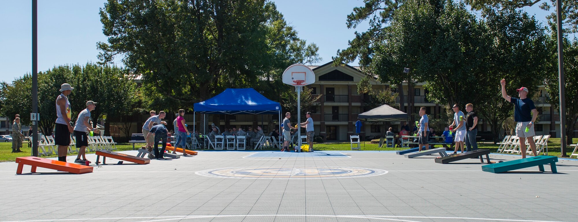 Members of Joint Base Charleston play corn hole during Oktoberfest Oct. 10, 2014, at the dorm picnic area on Joint Base Charleston, S.C. The event celebrated the contributions, sacrifice and service of JB Charleston’s first six (E1-E6) personnel, and featured free food, games, drinks and fun. (U.S. Air Force photo/Airman 1st Class Clayton Cupit)