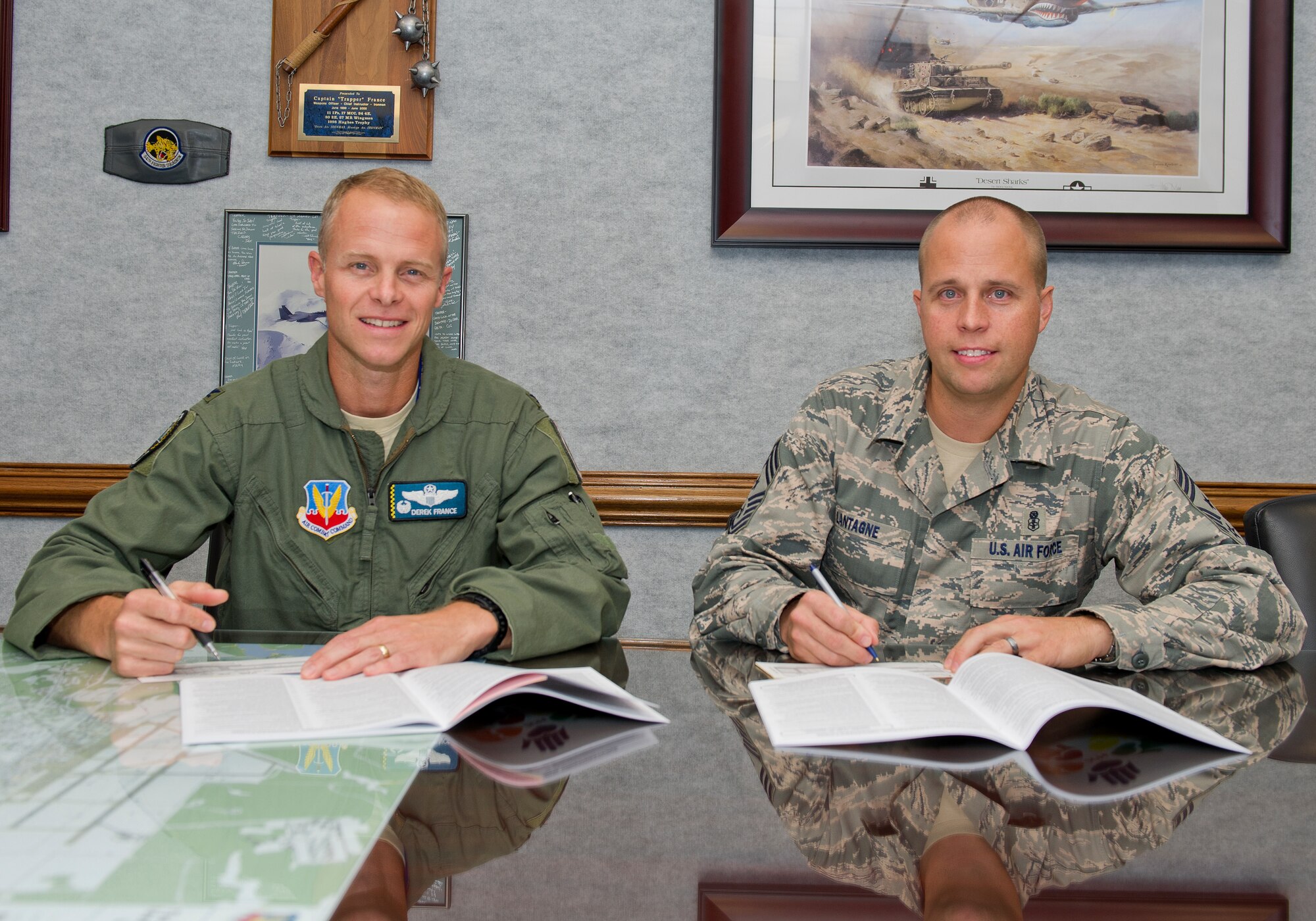 Col. Derek France, 325th Fighter Wing commander and Chief Master Sergeant Chris Lantagne, 325th FW command chief donate to the Combined Federal Campaign Oct. 14 at Tyndall. Tyndall representatives are collecting donations for the CFC until Nov. 21 to reach the overall goal of 15 percent base participation. (U.S. Air Force photo by Airman 1st Class Alex Echols)