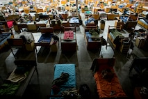 Beds are lined up in a hangar Oct. 8, 2014, at Avon Park Air Force Range, Fla. During Moody’s Wing Readiness Inspection, more than 200 Airmen deployed to Avon Park and lived in close quarters after duty hours. (U.S. Air Force Photo by Airman 1st Class Ryan Callaghan/Released)