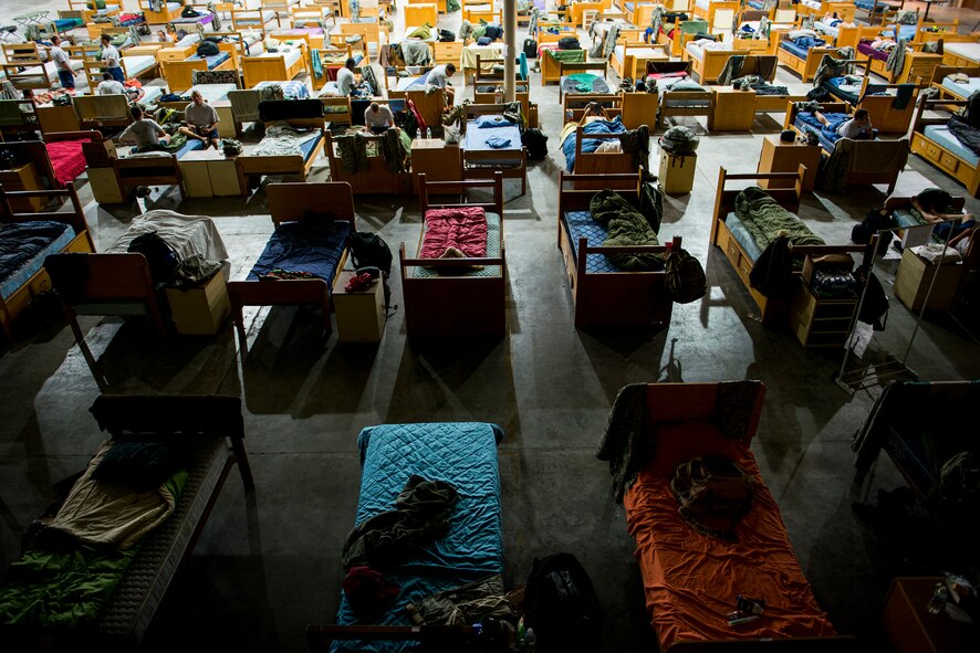 Beds are lined up in a hangar Oct. 8, 2014, at Avon Park Air Force Range, Fla. During Moody’s Wing Readiness Inspection, more than 200 Airmen deployed to Avon Park and lived in close quarters after duty hours. (U.S. Air Force Photo by Airman 1st Class Ryan Callaghan/Released)