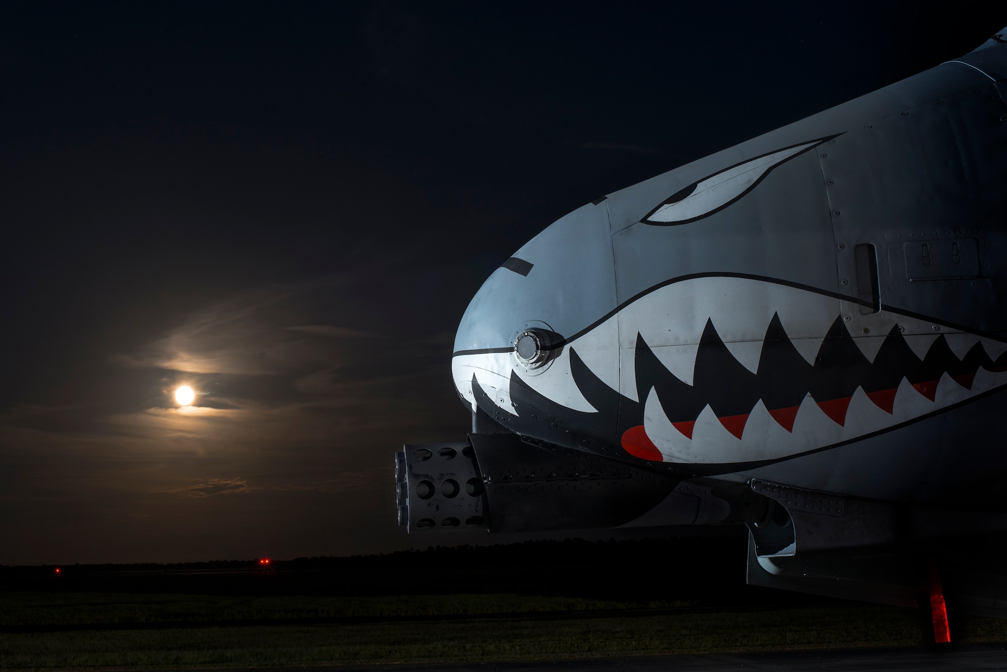 An A-10C Thunderbolt II sits on the flightline as the moon rises Oct. 8, 2014, at Avon Park Air Force Range, Fla. The A-10Cs supplied close air support to a combat search and rescue task force during an exercise. (U.S. Air Force Photo by Airman 1st Class Ryan Callaghan/Released)