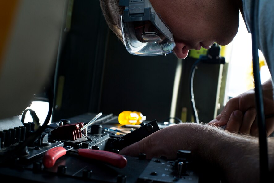 U.S. Air Force Senior Airman John Trice, 41st Helicopter Maintenance Unit electrical and environmental systems journeyman, solders connections on a battery voltmeter in an HH-60G Pave Hawk Oct. 8, 2014, at Avon Park Air Force Range, Fla. The 41st HMU is responsible for ensuring the HH-60Gs are ready to fly at a moment’s notice. (U.S. Air Force Photo by Airman 1st Class Ryan Callaghan/Released)
