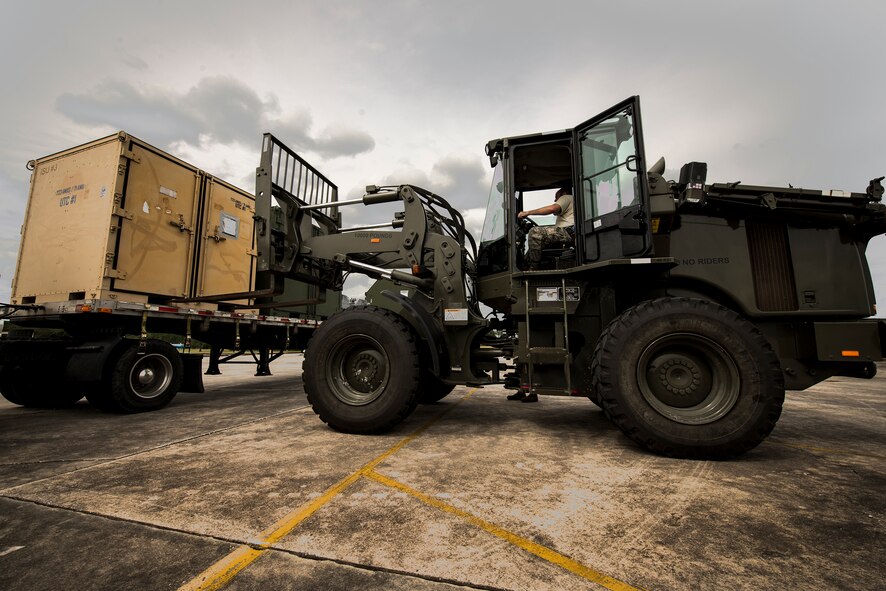 U.S. Air Force Staff Sgt. Paul Lusk, 23d Aircraft Maintenance Squadron support technician, uses a forklift to unload containers Oct. 7, 2014, at Avon Park Air Force Range, Fla. Moody Airmen processed more than 583 tons of cargo as part of a Wing Readiness Inspection. (U.S. Air Force Photo by Airman 1st Class Ryan Callaghan/Released)