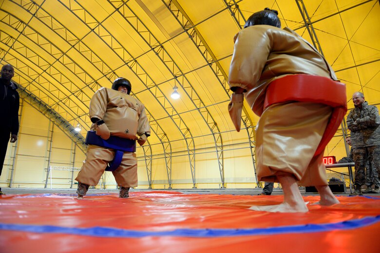 Col. Brian Barthel, 50th Mission Support Group commander (blue), stands in the ring with Adam Edwards, 50th Operations Group technical director, during the sumo-wrestling match at the Combined Federal Campaign kickoff Oct. 10, 2014, at Schriever Air Force Base, Colo. Edwards wrestled three commanders including Col. Bill Liquori, 50th Space Wing commander. (U.S. Air Force photo/Christopher DeWitt)