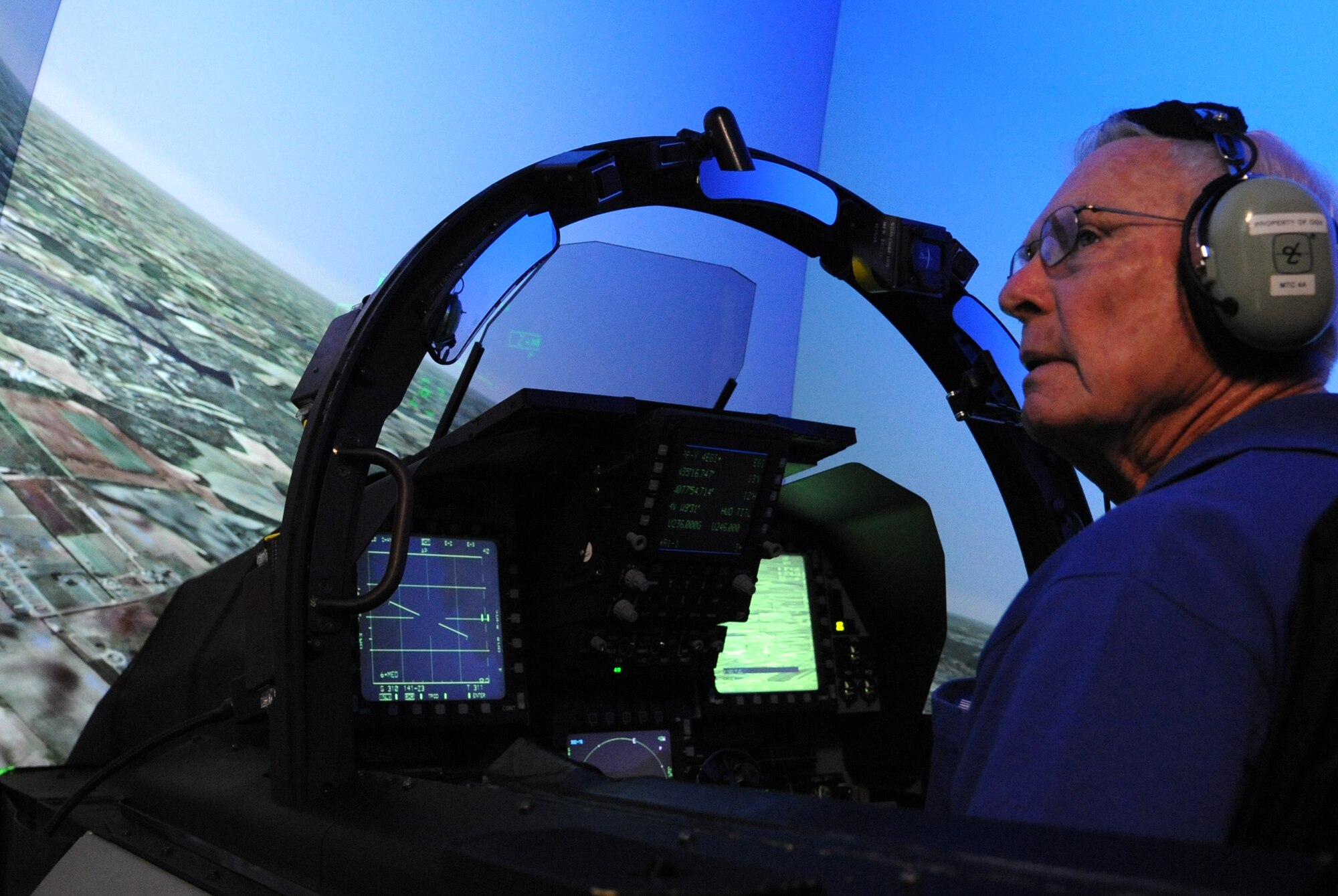 Retired Lt. Col. Robert Pardo surveys the surrounding area while in the F-15E Strike Eagle simulator at Seymour Johnson Air Force Base, North Carolina, Oct. 10, 2014. Pardo toured the base during his visit and spoke to the graduating pilots and weapons systems operators of the F-15E Basic Course. (U.S. Air Force photo/Airman 1st Class Ashley J. Thum)