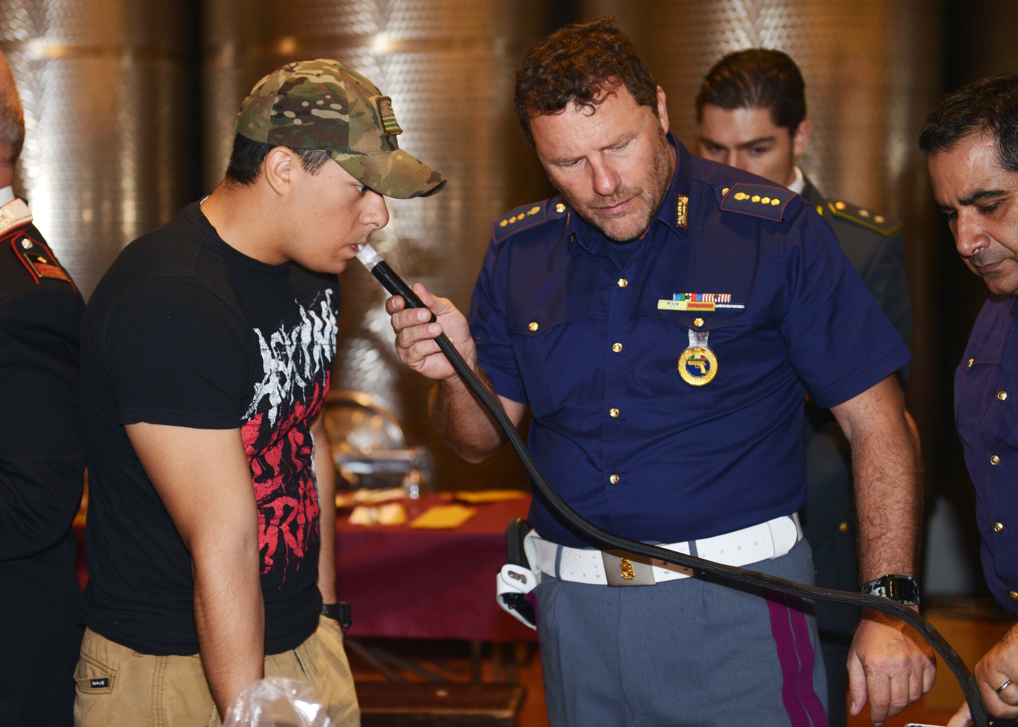 Senior Airman Miles Montoya, 31st Security Force Squadron, takes a breathalyzer test during a responsible drinking event, Oct. 11, 2014, in San Quirino, Italy. More than 40 Airmen attended the event to learn about responsible drinking and Italian drinking and driving laws. (U.S. Air Force photo/Airman 1st Class Deana Heitzman)