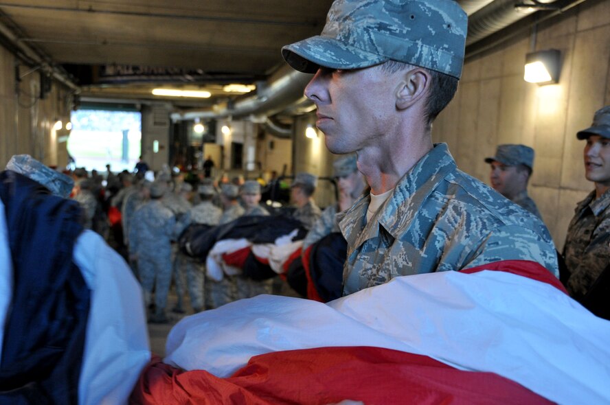 Airmen from the 442d Fighter Wing join their counterparts from the Army and active duty Air Force out of Whiteman Air Force Base wait in the tunnel of Royals stadium October 14, 2014 in preparation for the flag detail to open the third game of the American League Central Series. More than 100 members from Whiteman AFB, many Kansas City natives, volunteered to participate in the Royals’ most successful season in 30 years. (Air Force photo by Tech. Sgt. Emily F. Alley)