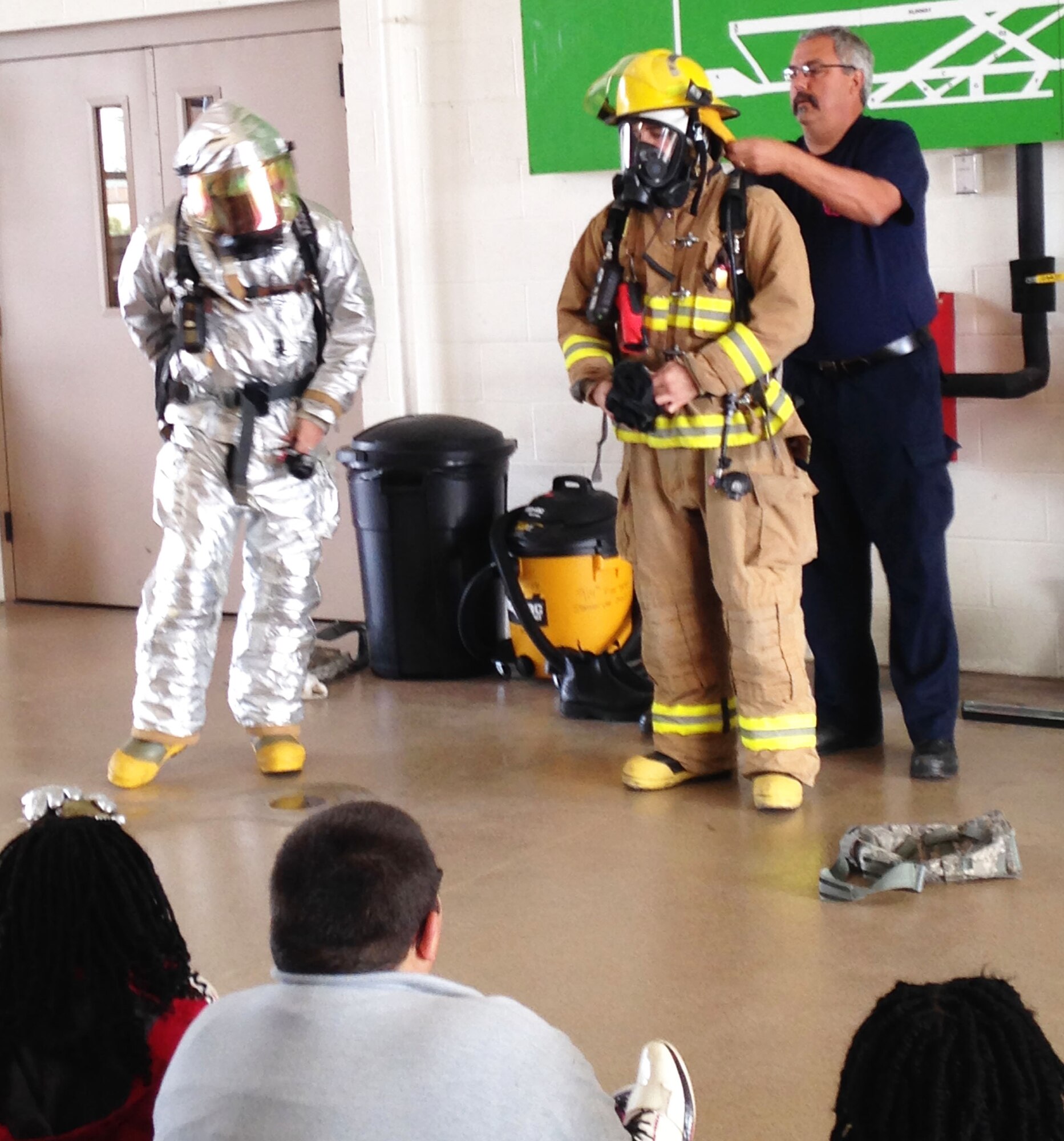 Richard Kennerson, Fire Chief, 914th Fire Emergency Services demonstrates different firefighting equipment to students, October 7, 2014. Students from a local school came to the Fire Department to learn about fire safety for Fire Prevention Week. (U.S. Air Force Photo by Staff Sgt. Matthew Burke)