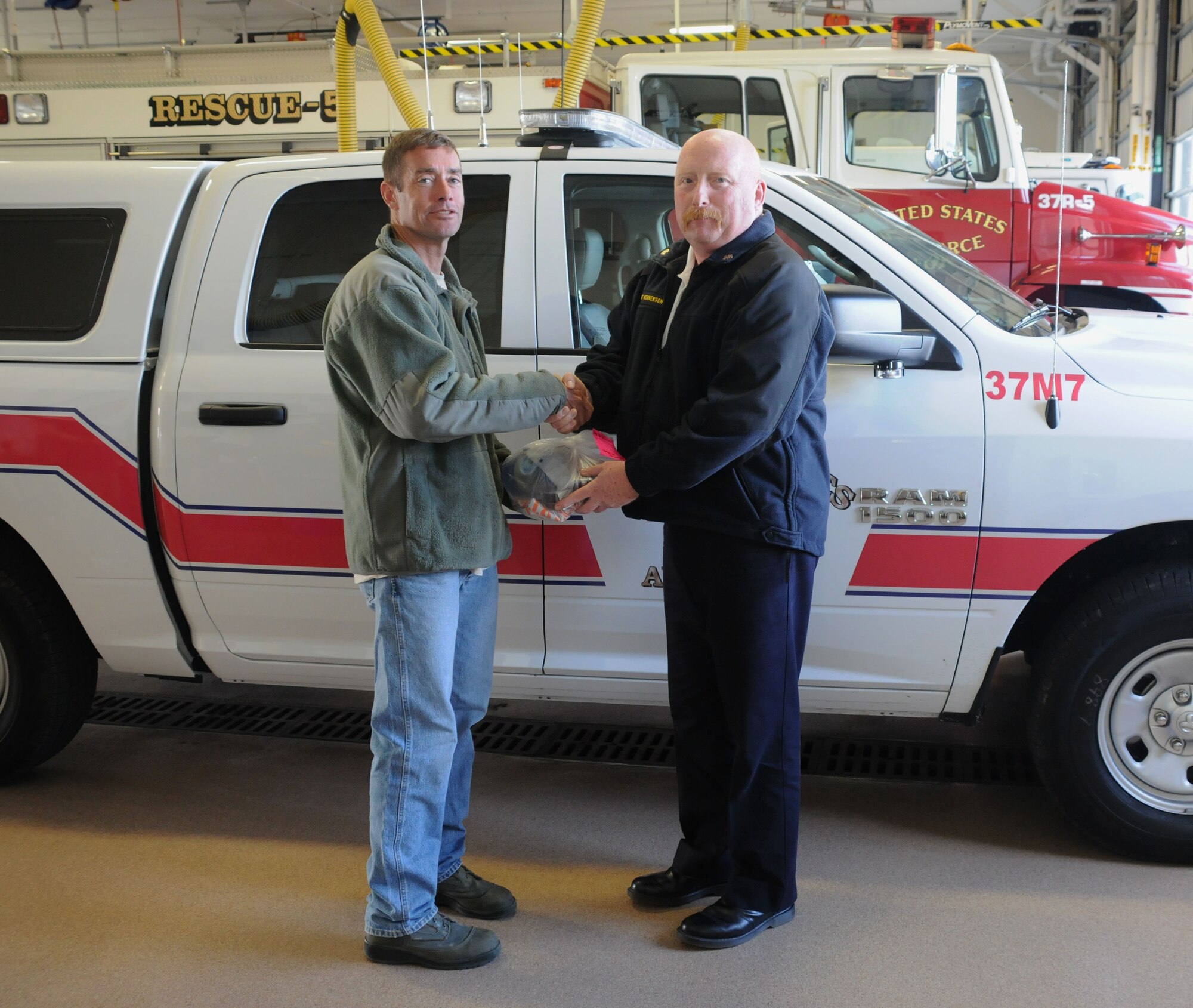 Richard Kennerson, Fire Chief, 914th Fire Emergency Services presents Master Sgt. Kenneth Dawley, 914 AMXS a prize, October 10, 2014. Dawley was awarded a prize which included fire safety equipment, for correctly answering and being randomly selected for a daily trivia contest. (U.S. Air Force Photo by Staff Sgt. Matthew Burke)