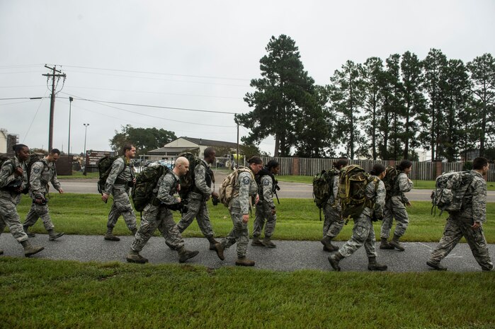 Members of the 1st Combat Camera Squadron march five miles during a ruck march Sept. 26, 2014, on Joint Base Charleston, S.C. A ruck march is a fast-paced hike done while carry heavy weight. The purpose of the ruck march was to train Airmen to capture critical imagery in austere conditions. (U.S. Air Force photo/Staff Sgt. Corey Hook)