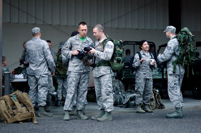 Members of the 1st Combat Camera Squadron prepare for a five-mile ruck march Sept. 26, 2014, on Joint Base Charleston, S.C. A ruck march is a fast-paced hike done while carry heavy weight. The purpose of the ruck march was to train Airmen to capture critical imagery in austere conditions. (U.S. Air Force photo/ Staff Sgt. Paul Labbe) 