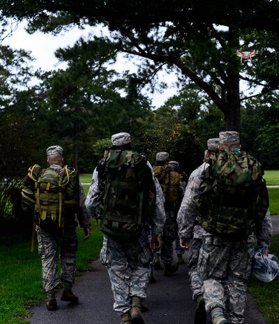 Members of the 1st Combat Camera Squadron march during a ruck march Sept. 26, 2014, on Joint Base Charleston, S.C. A ruck march is a fast-paced hike done while carrying heavy weight. The purpose of the ruck march was to train Airmen to capture critical imagery in austere conditions. (U.S. Air Force photo/Senior Airman Nicholas Byers)