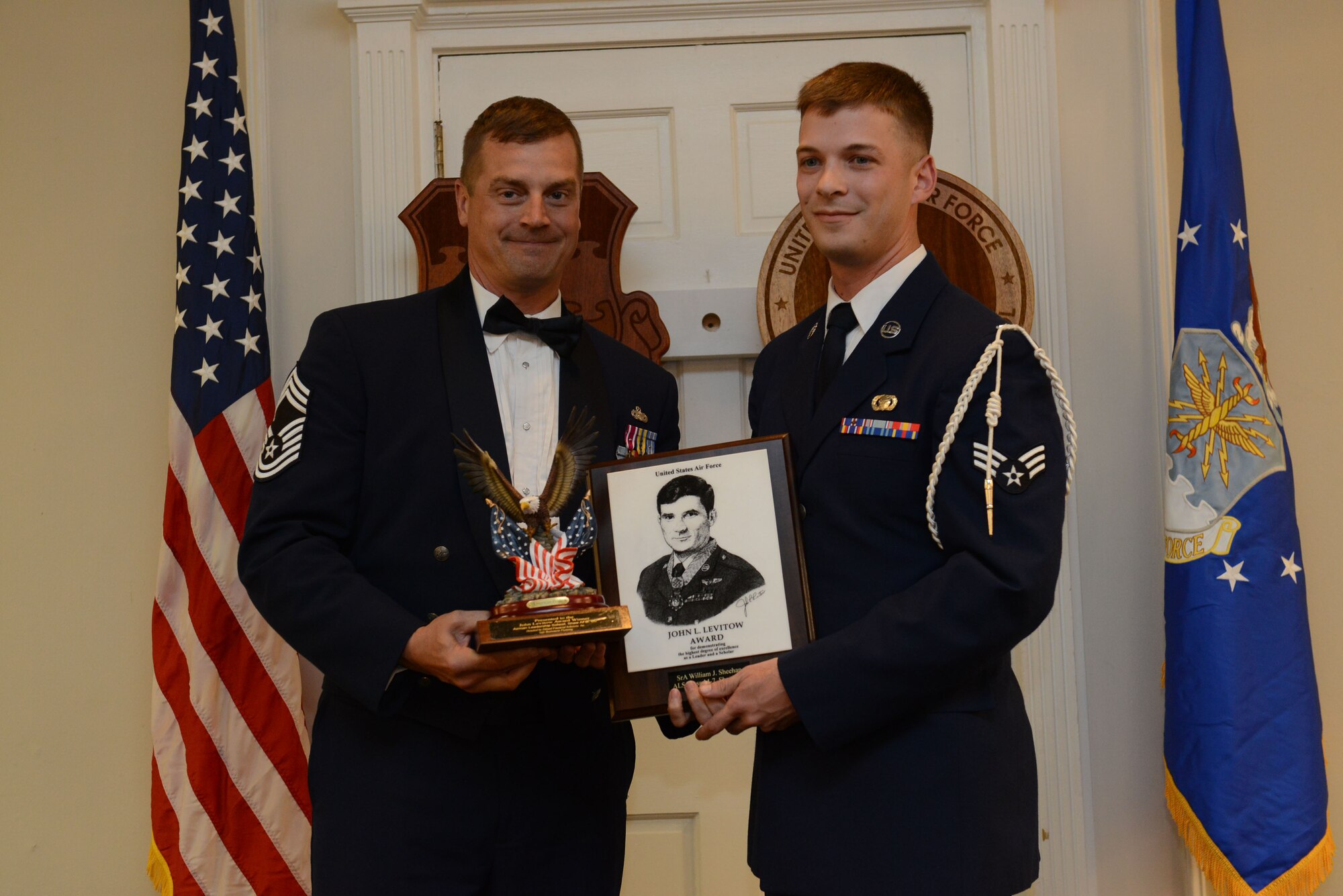 U.S. Air Force Senior Airman William Sheehan, 31st Intelligence Squadron (right), receives the John L. Levitow Award for the Senior Master Sgt. David B. Reid Airman Leadership School Class 14-7, from Chief Master Sgt. Scott McCalla, 20th Mission Support Group superintendent, at Shaw Air Force Base, S.C., Oct. 9, 2014. The Levitow Award is given to the graduate with the highest average of instructor and student points, and is the highest award in enlisted professional military education. (U.S. Air Force photo by Airman 1st Class Diana M. Cossaboom/Released)