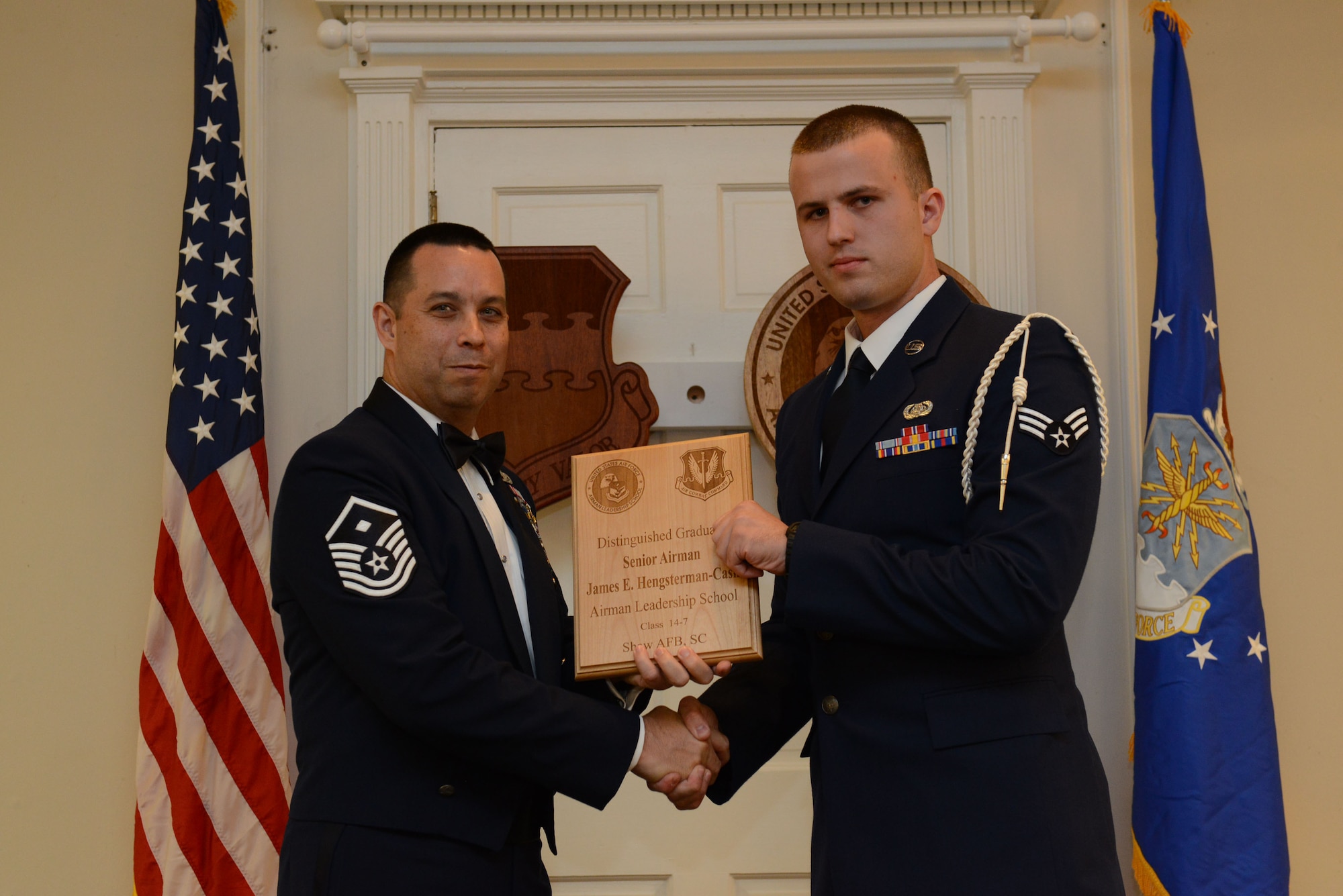 U.S. Air Force Senior Airman James Hengsterman-Cash, U.S. Air Forces Central (right), receives a distinguished graduate Award for Class 14-7 of the Senior Master Sgt. David B. Reid Airman Leadership School from Master Sgt. David Williams, Detachment 1, 609th Air and Space Operations Center first sergeant, at Shaw Air Force Base, S.C., Oct. 9, 2014. Distinguished graduate awards are given to the top 10 percent of the class for total point accumulation. (U.S. Air Force photo by Airman 1st Class Diana M. Cossaboom/Released)
