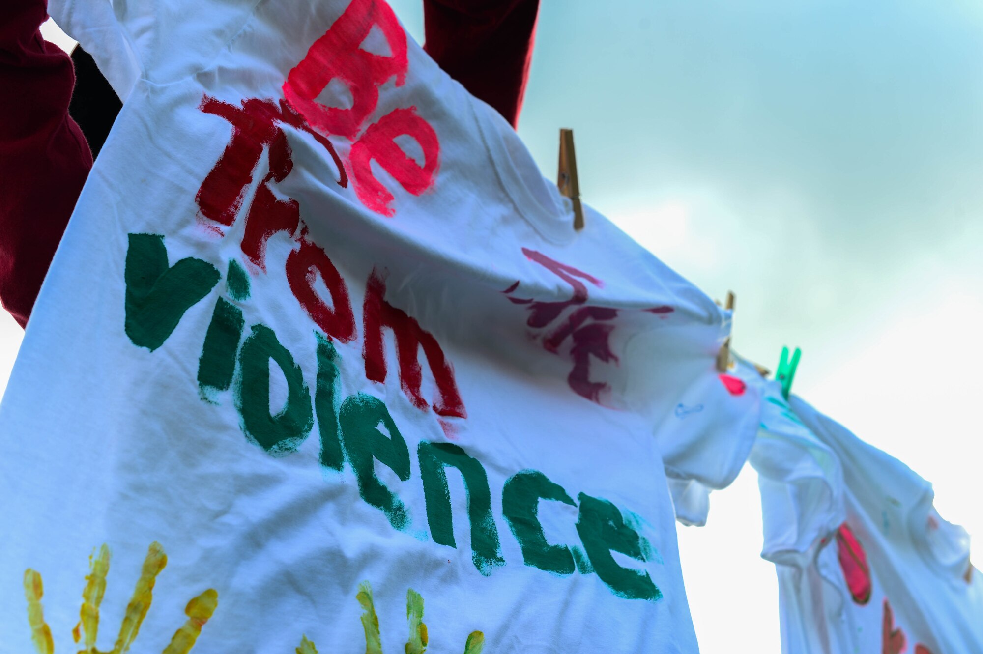 A shirt hangs from a clothes line outside the 52nd Force Support Squadron School Age Program building on Spangdahlem Air Base, Germany, Oct. 14, 2014. The 52nd Medical Operations Squadron Family Advocacy hosted the Clothes Line Project, which was created in 1990 to bring awareness to domestic violence. The 52nd Medical Operations Squadron dedicated this event to the women who died or have been victimized at Spangdahlem. (U.S. Air Force photo by Airman 1st Class Kyle Gese/Released)