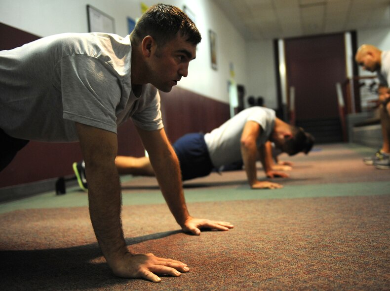 U.S. Air Force Capt. Dustin Bodine, 13th Bomb Squadron, performs push-ups during the Iron Airman Challenge at Whiteman Air Force Base, Mo., Oct. 10, 2014. To earn the title of Iron Airman the participant must receive a minimum score of 360 out of 400. (U.S. Air Force photo by Airman 1st Class Joel Pfiester /Released)