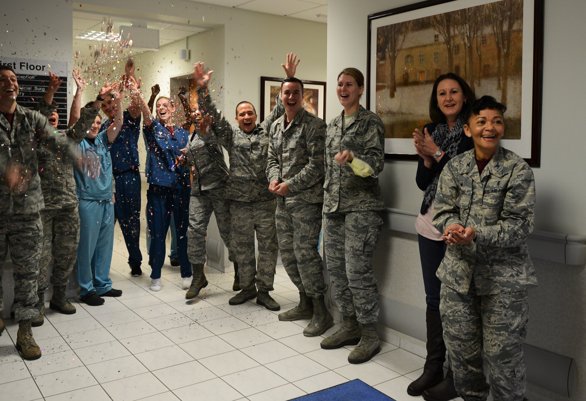 86th Dental Squadron personnel throw confetti and cheer as the fifth customer walks through the door to receive a United Service Organizations gift voucher during Customer Service Week on Ramstein Air Base, Germany, Oct. 10, 2014. The 86th Medical Group celebrated Customer Service week throughout the week with a variety of fun competitions. (U.S. Air Force photo/Senior Airman Hailey Haux)