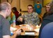 U.S. Air Force Airman 1st Class James Towles, 36th Intelligence Squadron targeteer, converses with peers during a bible study at Langley Air Force Base, Va., Sept. 30, 2014. The weekly dinner and study for dormitory residents currently takes place in the First Term Airman Center, but will change venues in February 2015. The event is not exclusive to single Airmen. (U.S. Air Force photo by Airman 1st Class Devin Scott Michaels/Released)