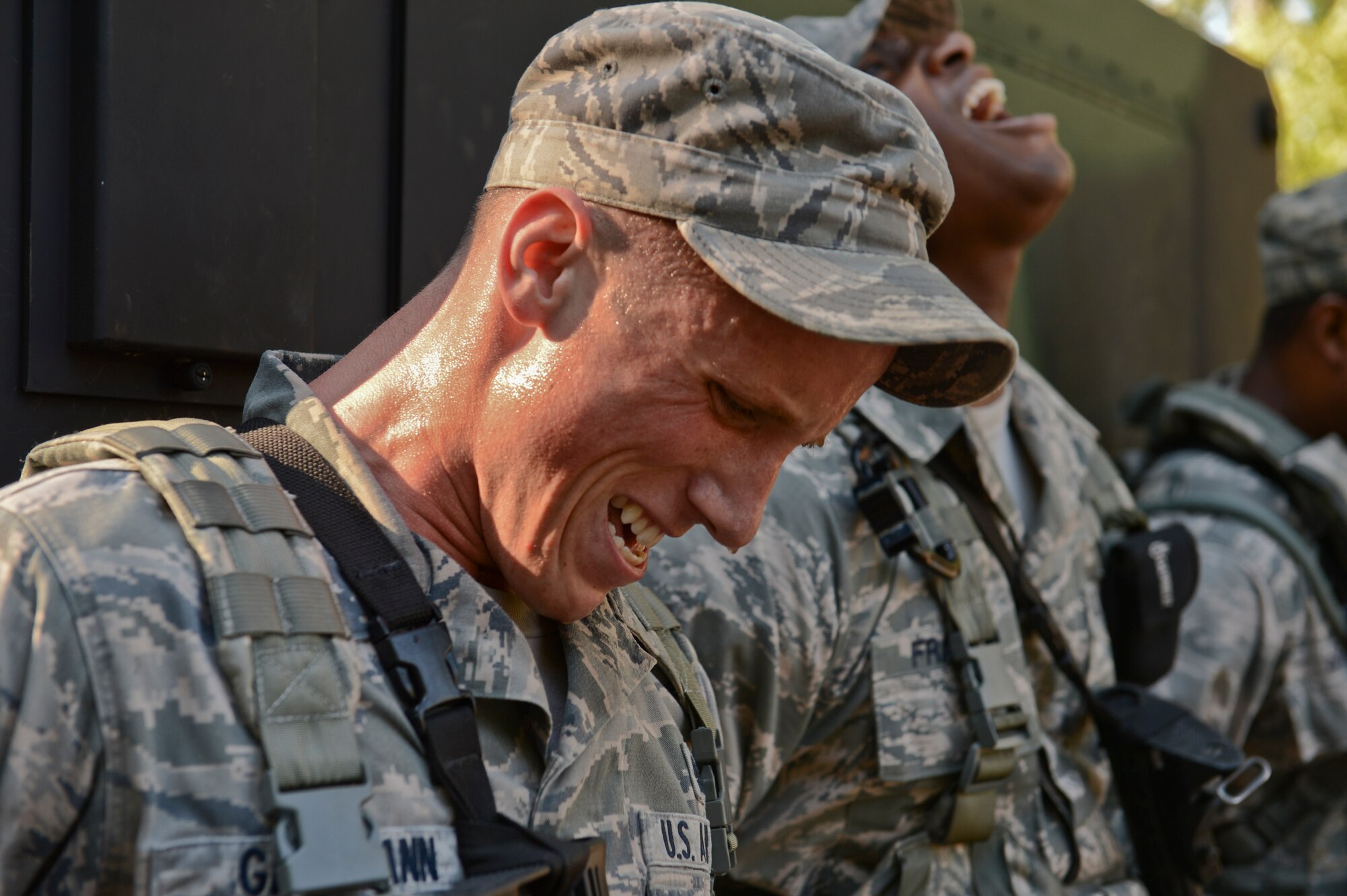 U.S. Air Force Senior Airman Zachary Gartmann, 20th Security Forces Squadron entry controller, and his teammates push a Humvee with other team members during the Defenders Edge Challenge at Shaw Air Force Base, S.C., Oct. 8, 2014. Each team was given 30 minutes to complete each of 10 obstacles. (U.S. Air Force photo by Senior Airman Tabatha Zarrella/Released)