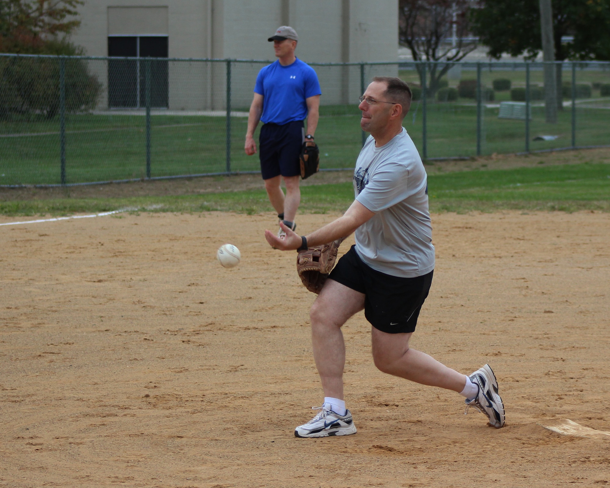 Chief Master Sgt. Stanley Cadell, 436th Airlift Wing command chief, throws a pitch during the Eagles versus Chiefs softball game Oct. 10, 2014, at Dover Air Force Base, Del. The Eagles fielded a roster of Team Dover colonels, while the Chiefs fielded Team Dover chief master sergeants and selected enlisted members. (U.S. Air Force photo/Herbert E. Welday III)