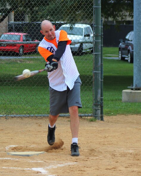 Senior Master Sgt. Steven Dirksen, 9th Airlift Squadron loadmaster superintendent, connects with a softball during the Eagles versus Chiefs softball game Oct. 10, 2014, at Dover Air Force Base, Del. The Chiefs defeated the Eagles, 13-8. (U.S. Air Force photo/Herbert E. Welday III)