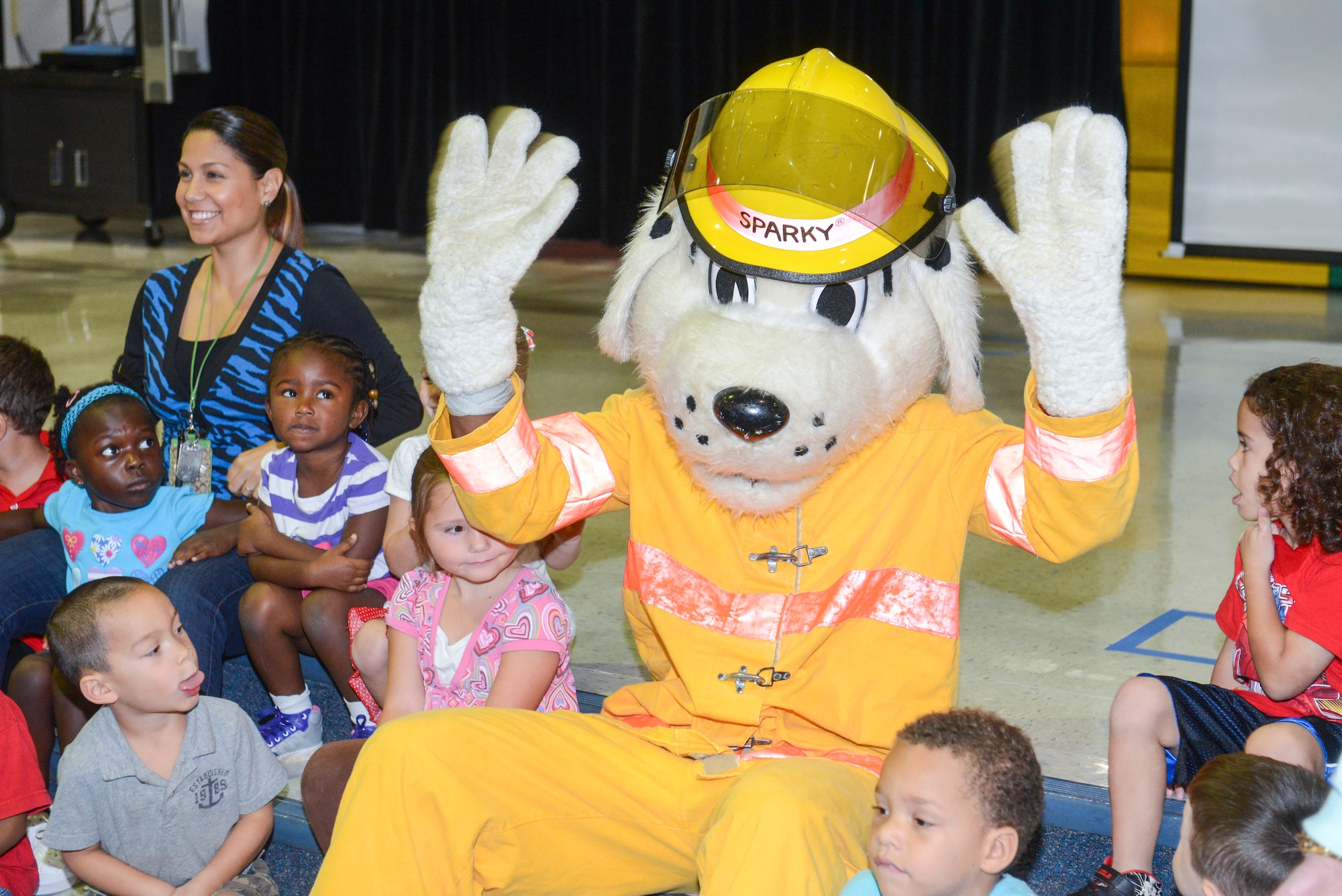 Sparky the Fire Dog waves at the students from Andersen Elementary School on Andersen Air Force Base, Guam Oct. 8, 2014. 36th CES visited the elementary school to raise awareness about Fire Prevention week (U.S. Air Force photo by Airman 1st Class Adarius Petty/Released)
