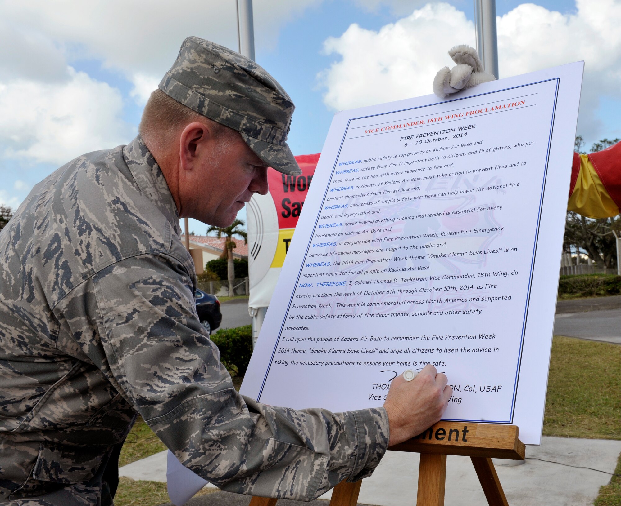 U.S. Air Force Col. Thomas Torkelson, 18th Wing vice commander, signs a proclamation initiating 2014 Fire Prevention Week on Kadena Air Base, Japan, Oct. 15, 2014. Oct. 5-11 is Fire Prevention Week. This year's theme is "Working Smoke Alarms Save Lives: Test Yours Every Month." Working smoke alarms cut the risk of dying in fires in half by giving you time to escape deadly smoke and flames. (U.S. Air Force photo by Naoto Anazawa/Released)