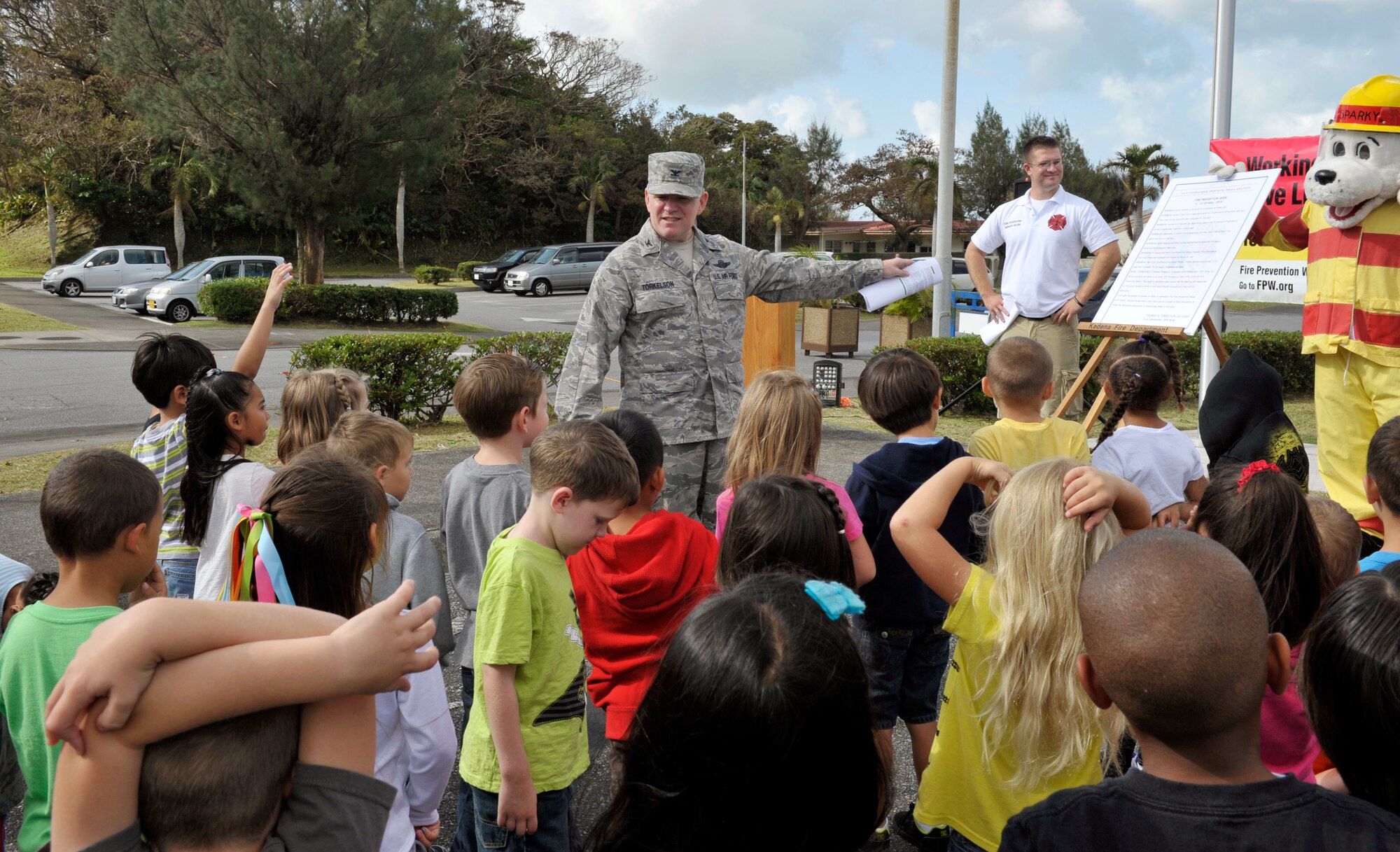 U.S. Air Force Col. Thomas Torkelson, 18th Wing vice commander, answers questions from Stearly Heights Elementary students about a proclamation initiating 2014 Fire Prevention Week on Kadena Air Base, Japan, Oct. 15, 2014. "Working Smoke Alarms Save Lives: Test Yours Every Month" is the theme for Fire Prevention Week 2014. Fire Prevention Week is dedicated to educating the public about the importance of fire safety. During fire prevention week, the fire department will sponsor activities for children across the base to educate children and their parents on fire prevention and detection.  (U.S. Air Force photo by Naoto Anazawa/Released)