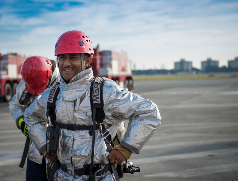 Senior Airman Ariful Haque from the 374th Civil Engineer Squadron, dons fire protection before competing in the fire muster at Yokota Air Base, Japan, Oct. 10, 2014. Airmen had the opportunity to bond and meet others from different squadrons during the event. (U.S. Air Force photo by Airman 1st Class Meagan Schutter/Released)