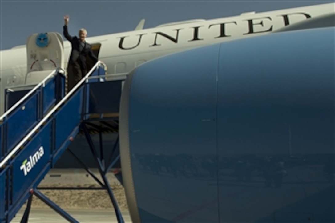 Defense Secretary Chuck Hagel waves goodbye as he prepares to depart Arequipa, Peru, after attending the 11th Conference of the Defense Ministers of the Americas, Oct. 14, 2014. 