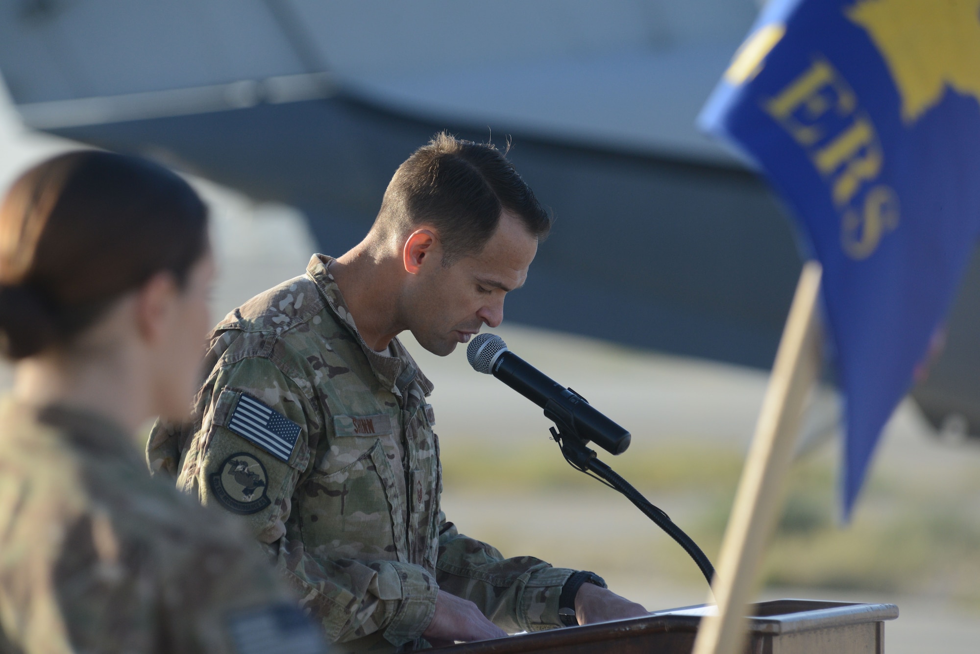 U.S. Air Force Master Sgt. Thomas Shinn, 4th Expeditionary Reconnaissance Squadron superintendent narrates the MC-12W transition of authority ceremony at Bagram Airfield, Afghanistan Oct. 1, 2014. The 4 ERS inactivated and Joint Task Force Thor is now the lead for the MC-12W mission in Afghanistan in Afghanistan. (U.S. Air Force photo by Master Sgt. Cohen A. Young/Released)