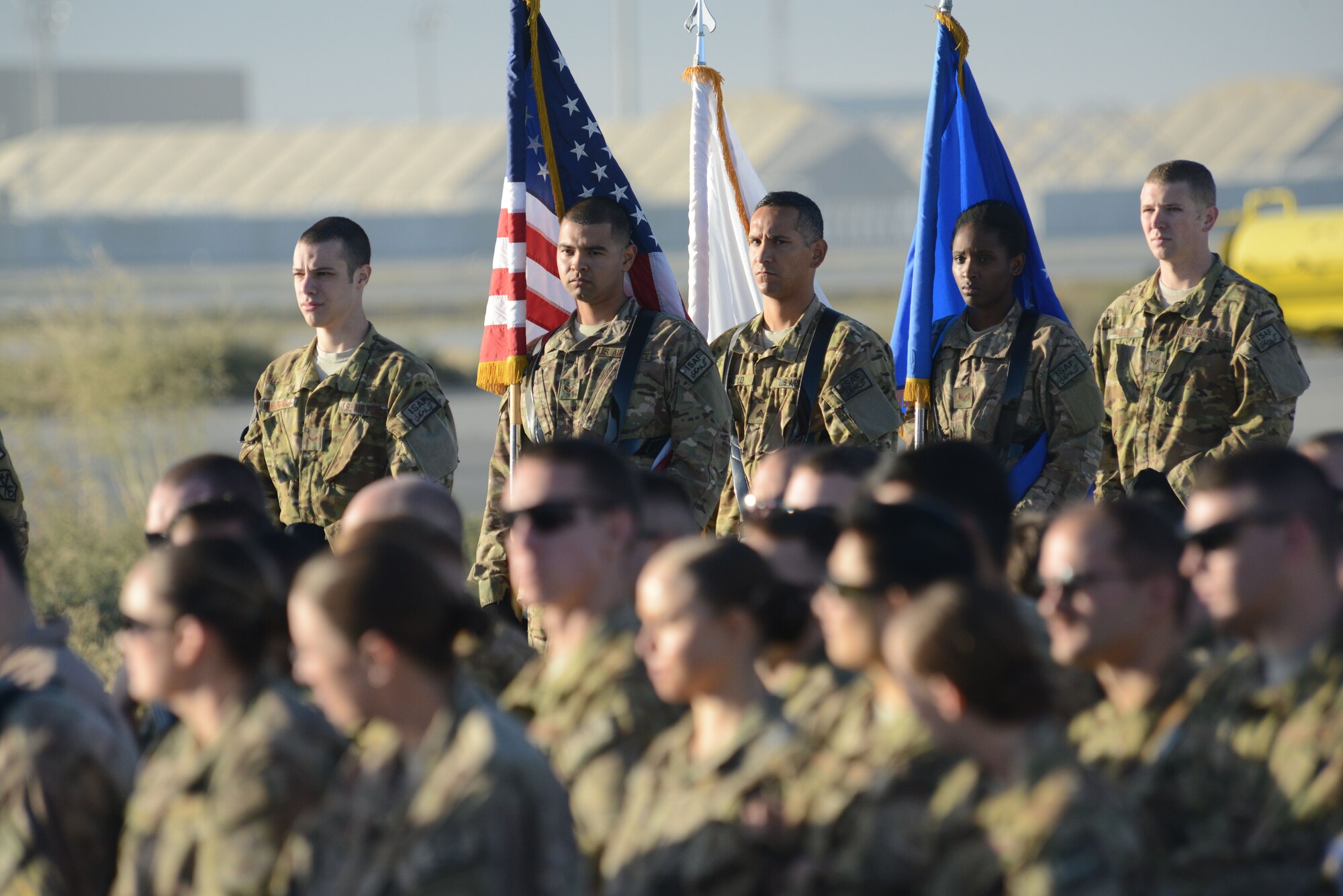 455th Air Expeditionary Wing honor guardsmen stand by waiting for the start of the MC-12W transition of authority ceremony on the flight line of Bagram Airfield, Afghanistan Oct. 1, 2014. The 4 ERS inactivated and Joint Task Force Thor is now the lead for the MC-12W mission in Afghanistan. (U.S. Air Force photo by Master Sgt. Cohen A. Young/Released)