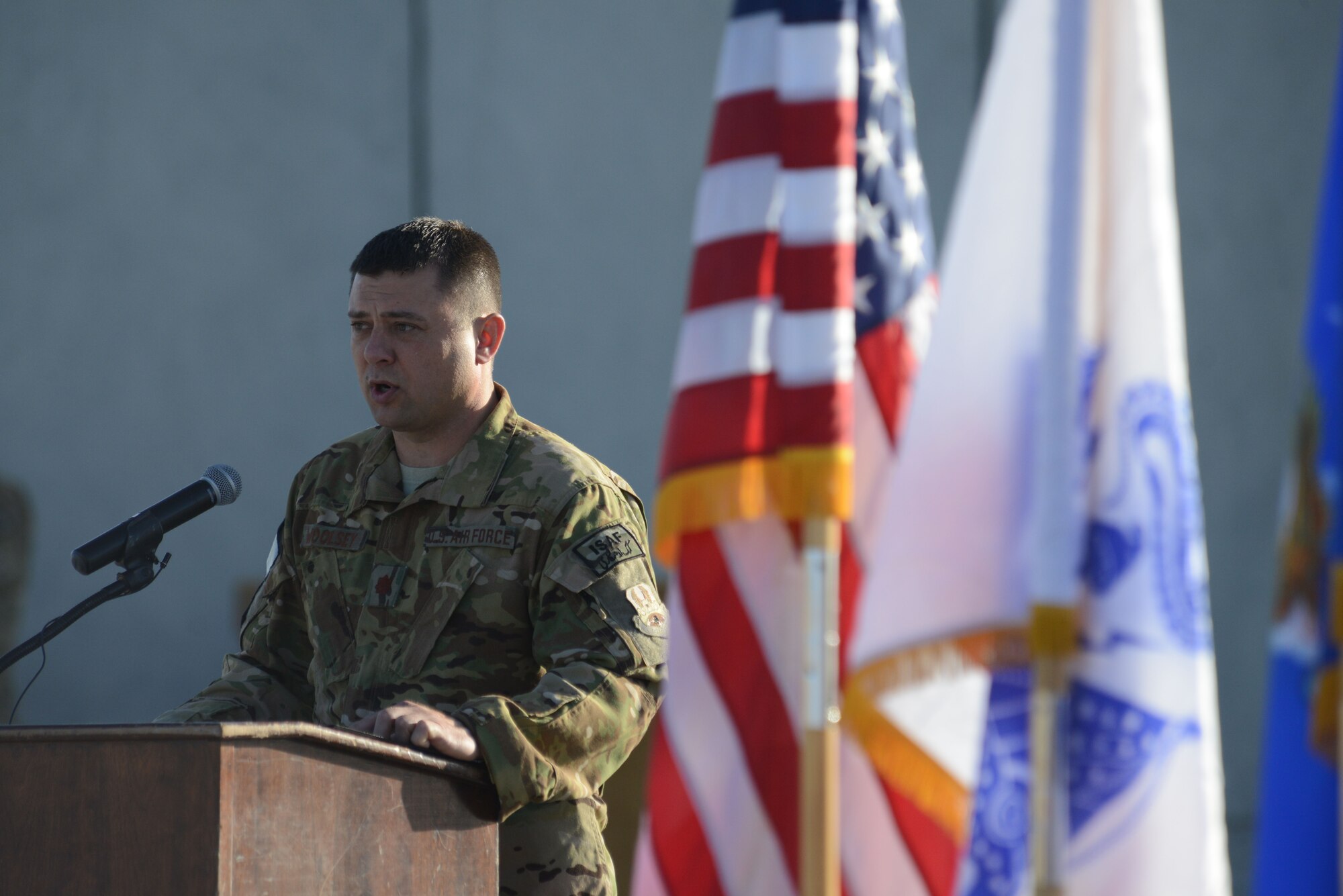 U.S. Air Force Maj. Tanner Woolsey, 4th Expeditionary Reconnaissance Squadron commander, speaks during the MC-12W transition of authority ceremony at Bagram Airfield, Afghanistan Oct. 1, 2014. The 4 ERS inactivated and Joint Task Force Thor is now the lead for the MC-12W mission. (U.S. Air Force photo by Master Sgt. Cohen A. Young/Released)