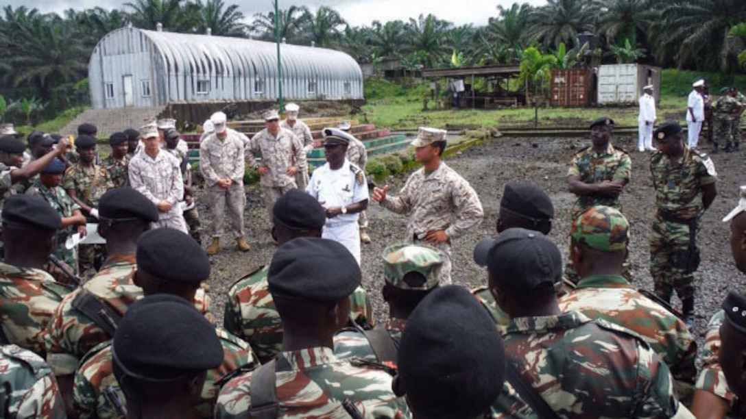 First Lieutenant Christopher Kohn, the officer-in-charge of Security Cooperation Team 5B, Special Purpose Marine Air Ground Task Force-Crisis Response-Africa, talks to the entire Cameroonian Naval Commando Company (COPALCO) unit and the SCT-5B team in Cameroon, Sept. 28, 2014. Kohn thanked the COPALCO and SCT-5B team members for their hard work and dedication to the training. SCT-5B worked with the COPALCO on marksmanship, boat operations, and patrolling. (Courtesy Photo)