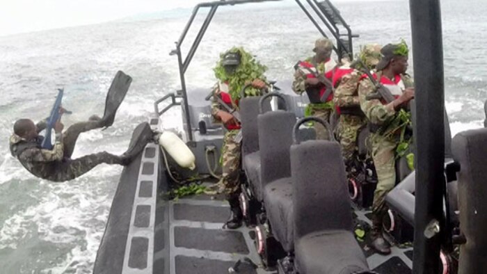 A service member with the Cameroonian Naval Commando Company jumps into the water to establish beach security for follow-on operations. The COPALCO worked with Marines, Sailors and Coast Guardsmen part of Special Purpose Marine Air Ground Task Force-Crisis Response-Africa, on marksmanship, boat operations, patrolling and noncommissioned officer leadership.