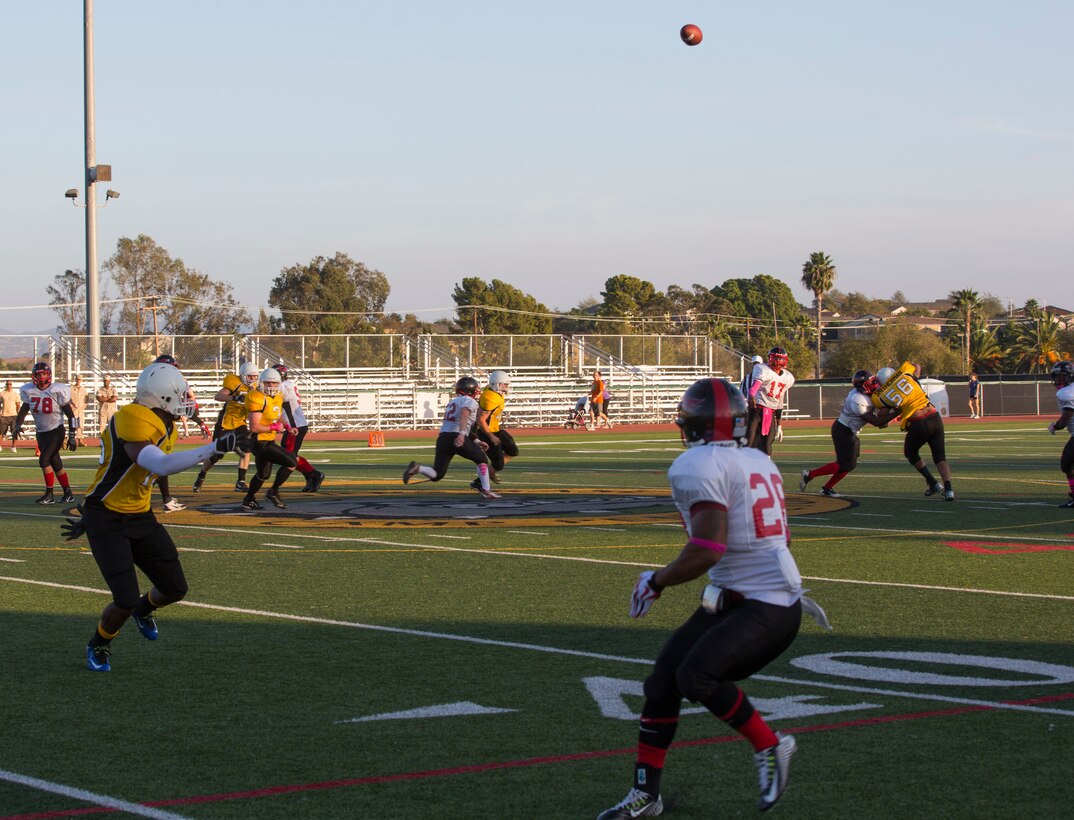 Lance Cpl. Jabari Moore, Marine Corps Air Station Miramar Falcons’ quarterback attempts a pass to Cpl. Kyle Byrdsong, Falcons’ wide receiver, during a football game against the 1st Marine Logistics Group Beasts at Paige Fieldhouse aboard Marine Corps Base Camp Pendleton, Calif., Oct. 14. The Falcons defeated to the Beasts 26-12, solidifying their spot in the upcoming playoffs. 