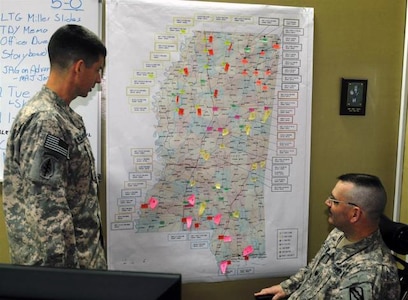 Maj. Brent McCullouch, intelligence officer with the 155th Heavy Brigade Combat Team and a Jackson, Miss., native, and Lt. Col. John K. Harlan, the operations officer with the 155th HBCT, also a Jackson native, plan out their part in the hurricane evacuation plan for the Mississippi National Guard, Feb. 8, at Contingency Operating Site Taji. The brigade re-deploys in the beginning of March and was tasked to do their planning while still in theater.