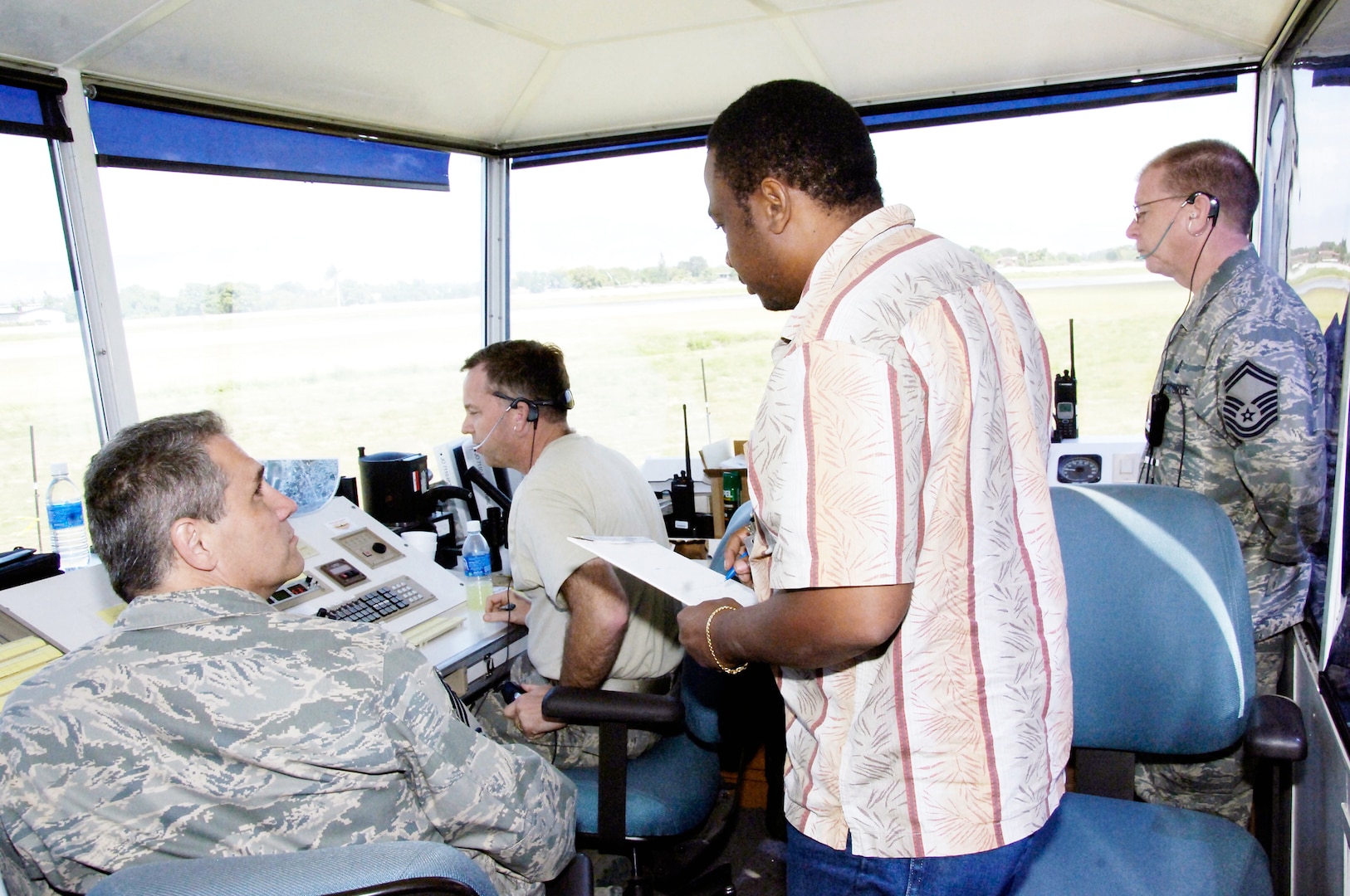 Reginald Bailey receives familiarization instruction from Air Force air traffic controllers in the mobile tower Feb. 1, 2010, at the airport in Port-au-Prince, Haiti. The transition is currently taking place to hand over the tower and all flight operations responsibilities over to the Haitians. Bailey is a Haitian air traffic controller. (U.S. Air Force photo/Tech. Sgt. Larry W. Carpenter Jr.)