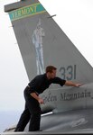 Senior Airman Steven Shepard examines an F-16 Falcon, which took part in Operation Snowbird at Davis-Monthan Air Force Base in Tucson, Ariz., Jan. 19, 2010. Shepard is a crew chief assigned to the 158the Fighter Wing of the Vermont Air National Guard, located in South Burlington, Vt.