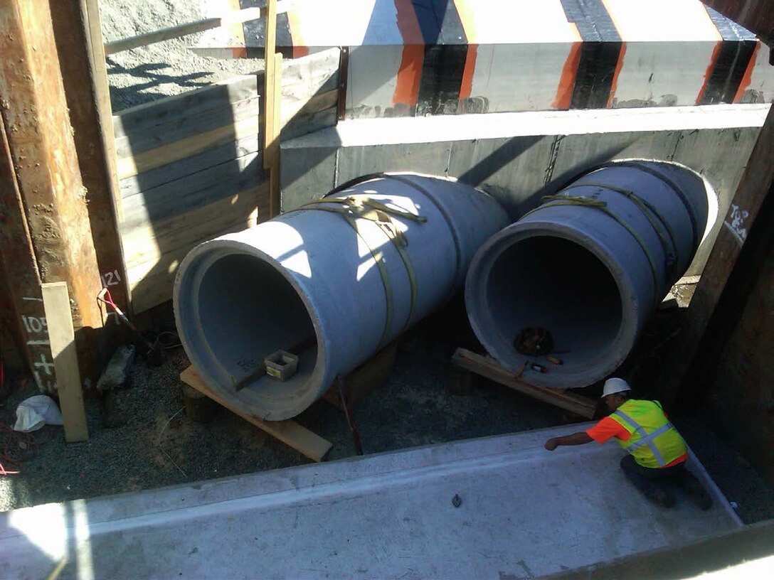 New 54-inch precast pipes coming out of the precast Brookline Avenue culvert, as part of the Muddy River Flood Risk Management Project, Boston, Mass. Note the cast-in-place slab in front of the pipes where the permanent precast concrete junction box will sit.
