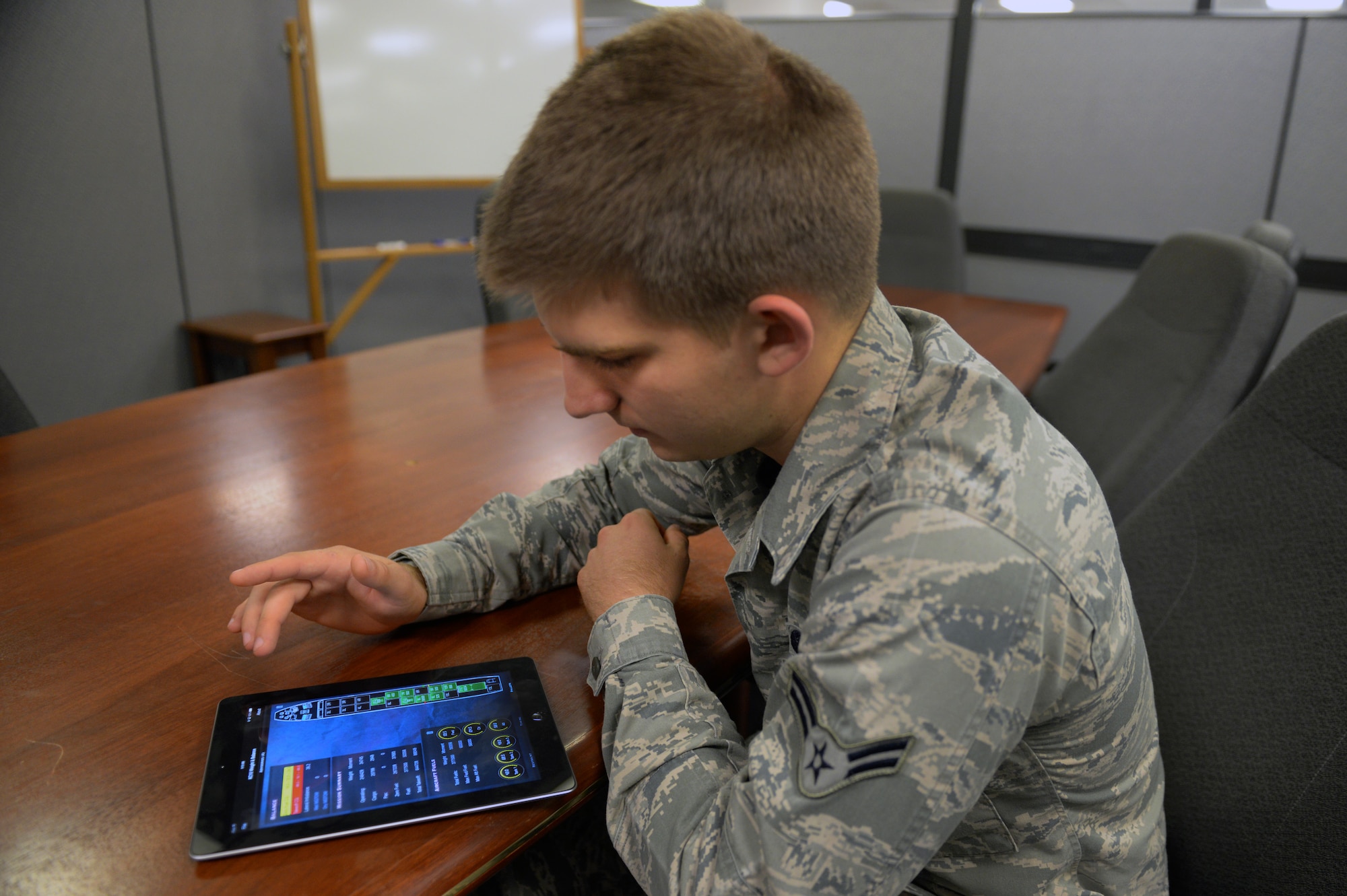 Airman 1st Class Carson Ponder reviews the features of the iPad KC-10 Load Management application Sept. 26, 2014, at Scott Air Force Base, Ill. He was part of a team of more than a dozen programmers that built the award winning app, which earned the "Outstanding Information Technology Achievement in Government" Award in the 27th Annual GCN Awards. Ponder is a 375th Communications Support Squadron programmer. (Courtesy photo)