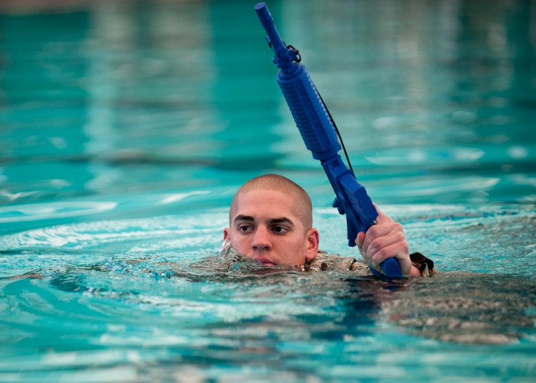 A Ranger Assessment Course student completes the water survival portion of the course Oct. 2, 2014, at the Municipal Pool in Las Vegas. During this portion of the test, students are required to keep their heads and weapons above the surface of the water. The two-week course develops a student’s ability to lead and command under heavy mental, emotional and physical stress. (U.S. Air Force photo/Airman 1st Class Thomas Spangler)