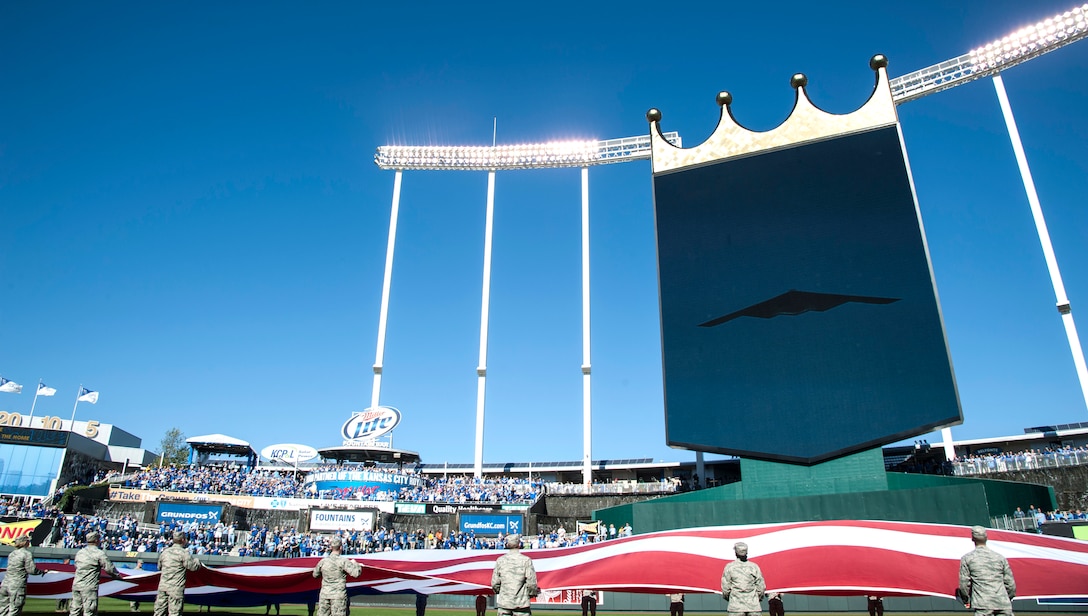 Airmen hold the American flag during the Royals vs. Orioles baseball game Oct. 15, 2014, at Kaufmann Stadium in Kansas City, Mo. The Airmen are assigned to the 509 and 131st Bomb wings at Whiteman Air Force Base, Mo. A B-2 Spirit stealth bomber made an appearance during the pre-game activities, representing the Air Force to a packed stadium as well as a TV viewership of millions during Game 4 of the American League Championship Series. (U.S. Air Force photo/Staff Sgt. Brigitte N. Brantley)