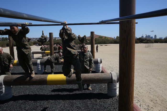 A Company A recruit with 1st Recruit Training Battalion, swings up on an obstacle during the Obstacle Course at Marine Corps Recruit Depot San Diego, Oct. 2. Recruits will run the course three more times while in recruit training.