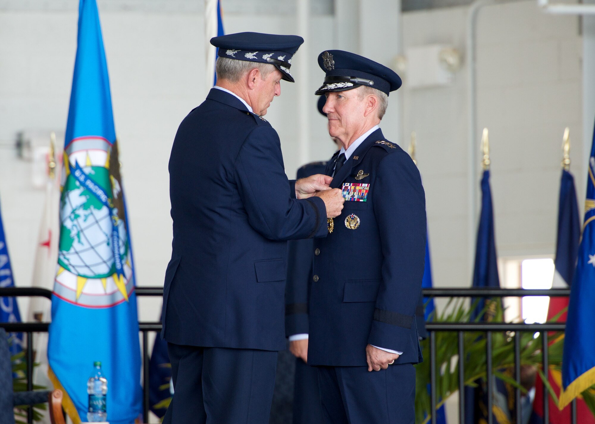 Air Force Chief of Staff Gen. Mark A. Welsh III presents Gen. Hawk Carlisle, outgoing Pacific Air Forces commander, with a Distinguished Service Medal during the PACAF change of command ceremony at Joint Base Pearl Harbor-Hickam, Hawaii, Oct. 16, 2014. Gen. Lori Robinson succeeded Carlisle during the ceremony. (U.S. Air Force photo by Capt. Raymond Geoffroy/Released)