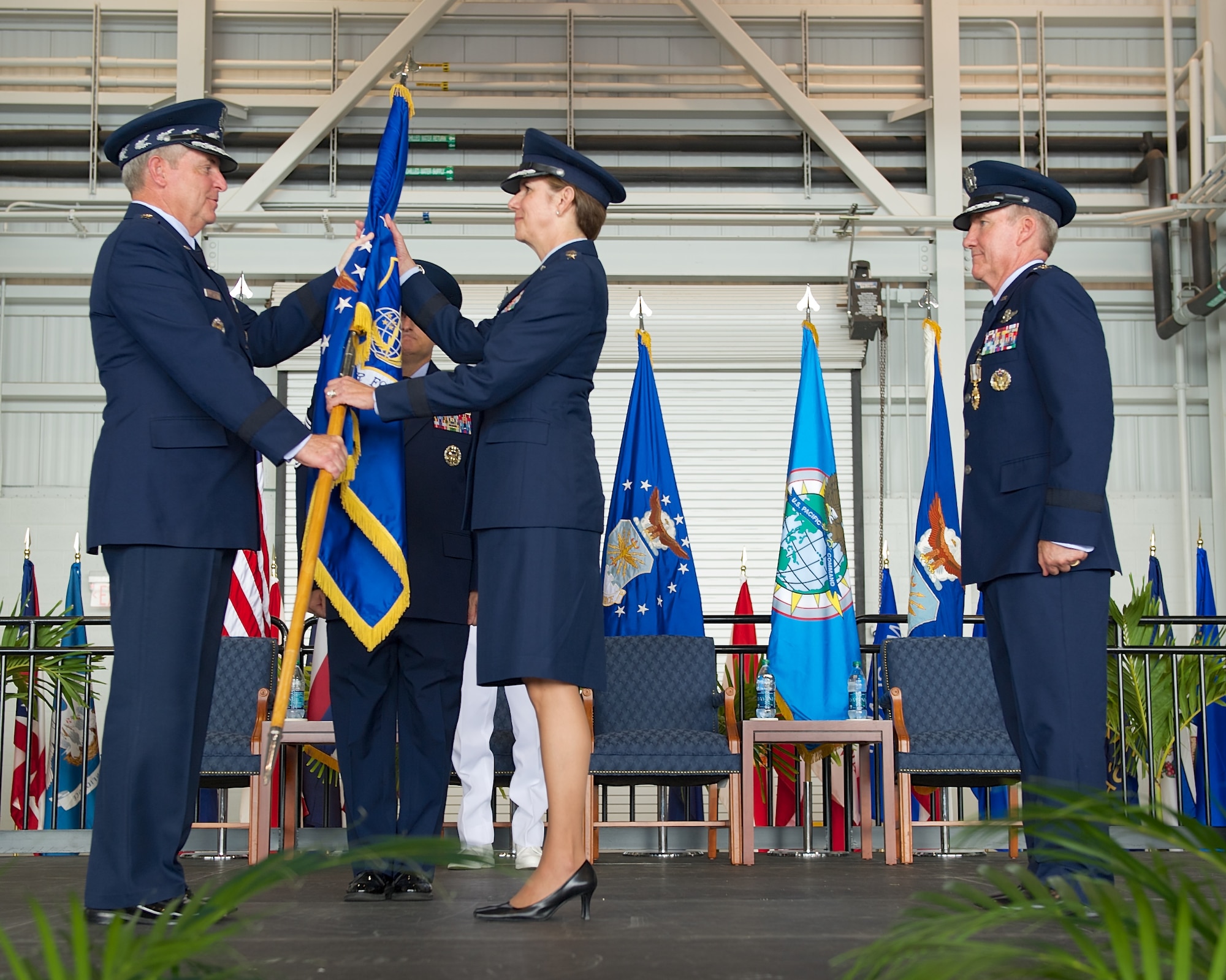 Gen. Lori Robinson, Pacific Air Forces commander, receives the PACAF flag from Air Force Chief of Staff Gen. Mark A. Welsh III during the PACAF change of command ceremony at Joint Base Pearl Harbor-Hickam, Hawaii, Oct. 16, 2014. Robinson now leads U.S. Air Force activities spread over half the globe in a command that supports 46,000 Airmen serving principally in Japan, Korea, Hawaii, Alaska and Guam. (U.S. Air Force photo by Tech. Sgt. James Stewart/Released)